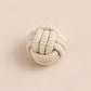 Textured rope knot on a beige background