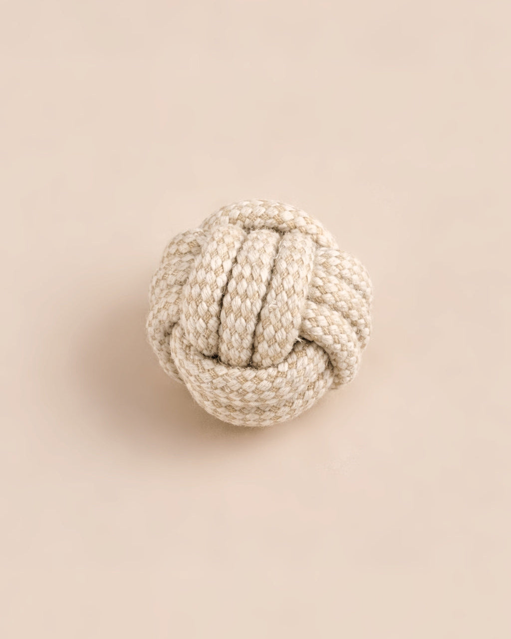 Textured rope knot on a beige background